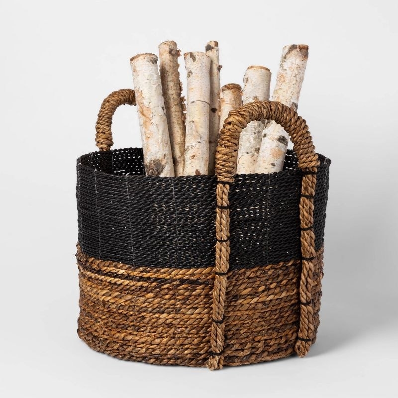 back and brown basket holding chopped birch wood