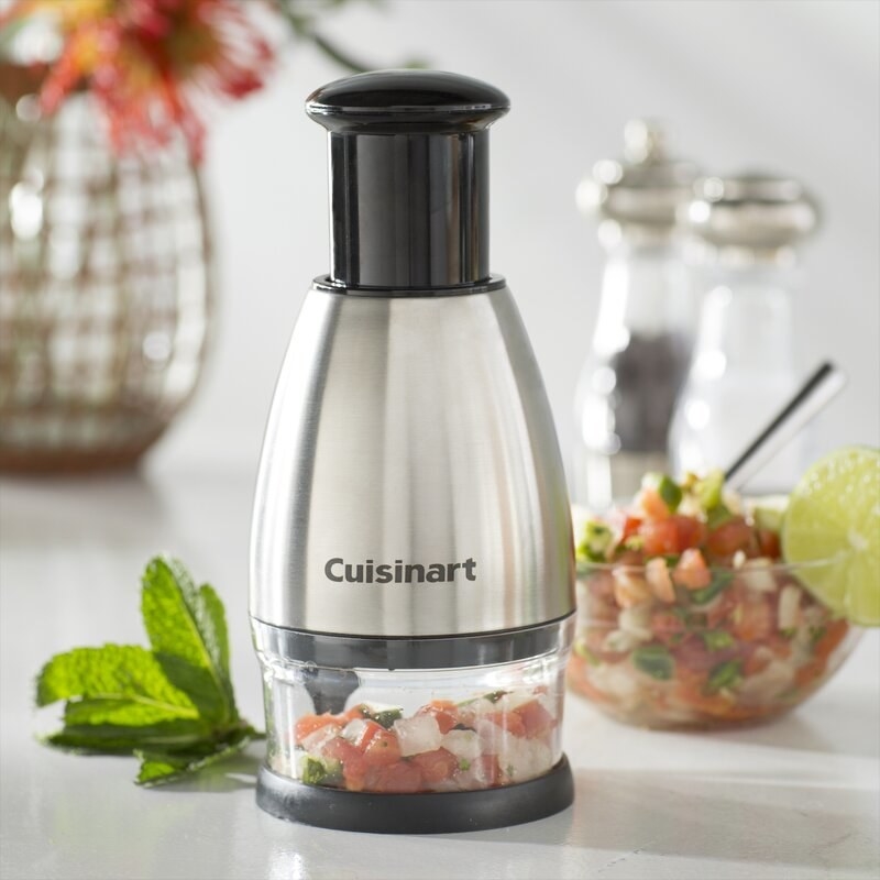 Stainless steel cuisinart food chopper with chopped tomatoes and onions inside