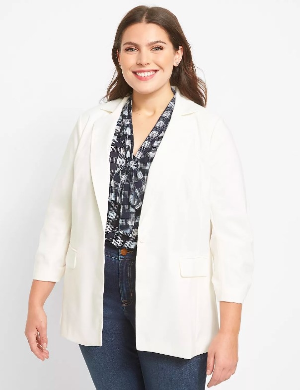 Model wearing white white blazer with printed top and jeans