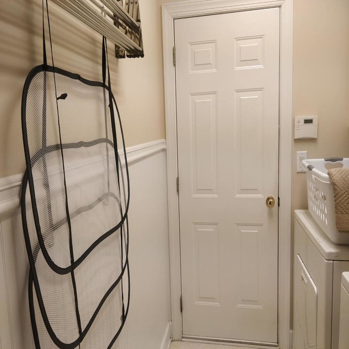 The drying rack is shown up against a wall because it's not in use