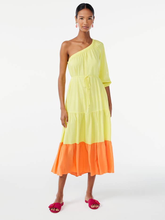 model wearing yellow and orange color-blocked dress with red sandals