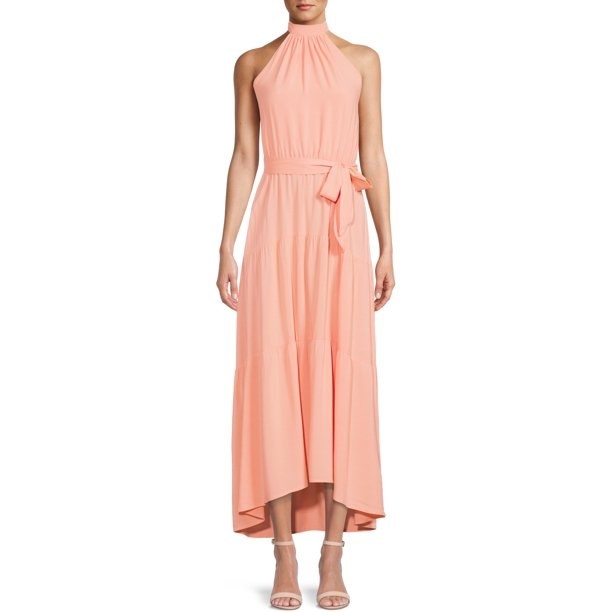 model wearing peach-colored maxi dress with matching sandals