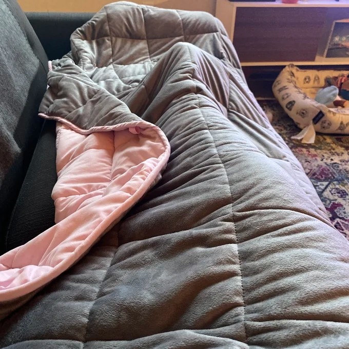 Reviewer&#x27;s photo of the weighted blanket in the color Pink
