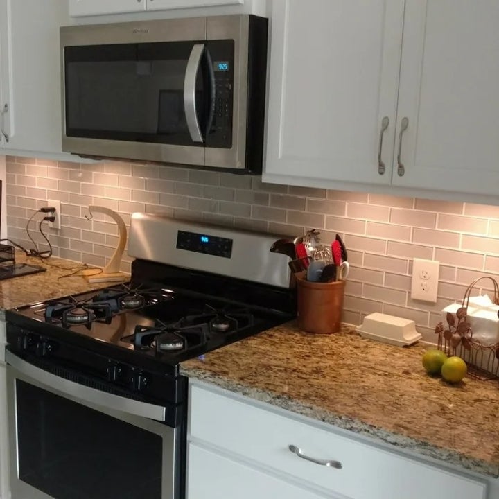 Reviewer's photo of the puck lights used underneath kitchen cabinets