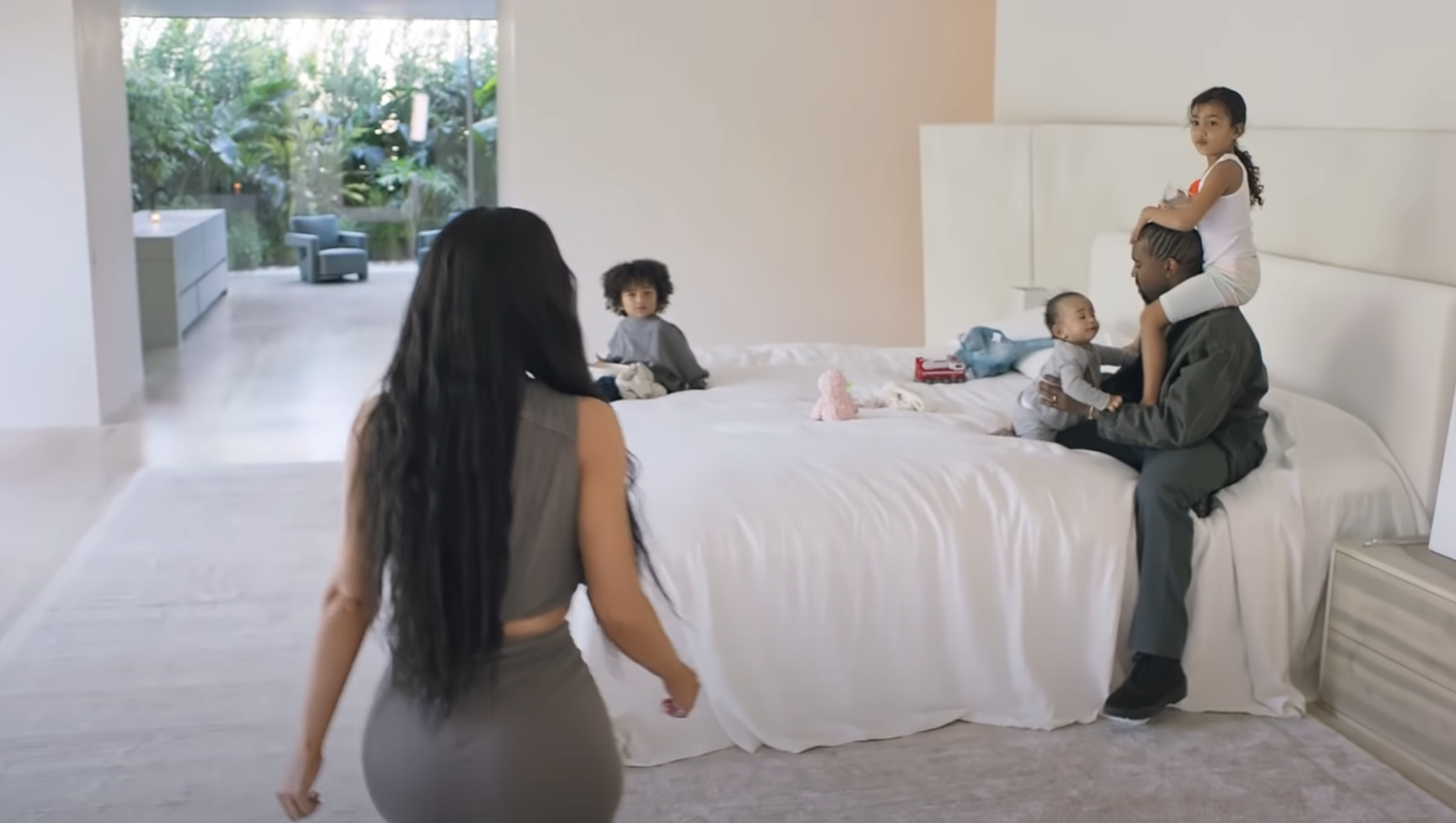 Kim in her bedroom with Kanye and their kids
