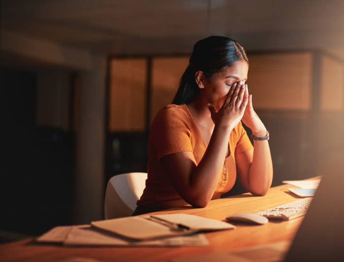 A woman stressed out at her computer desk