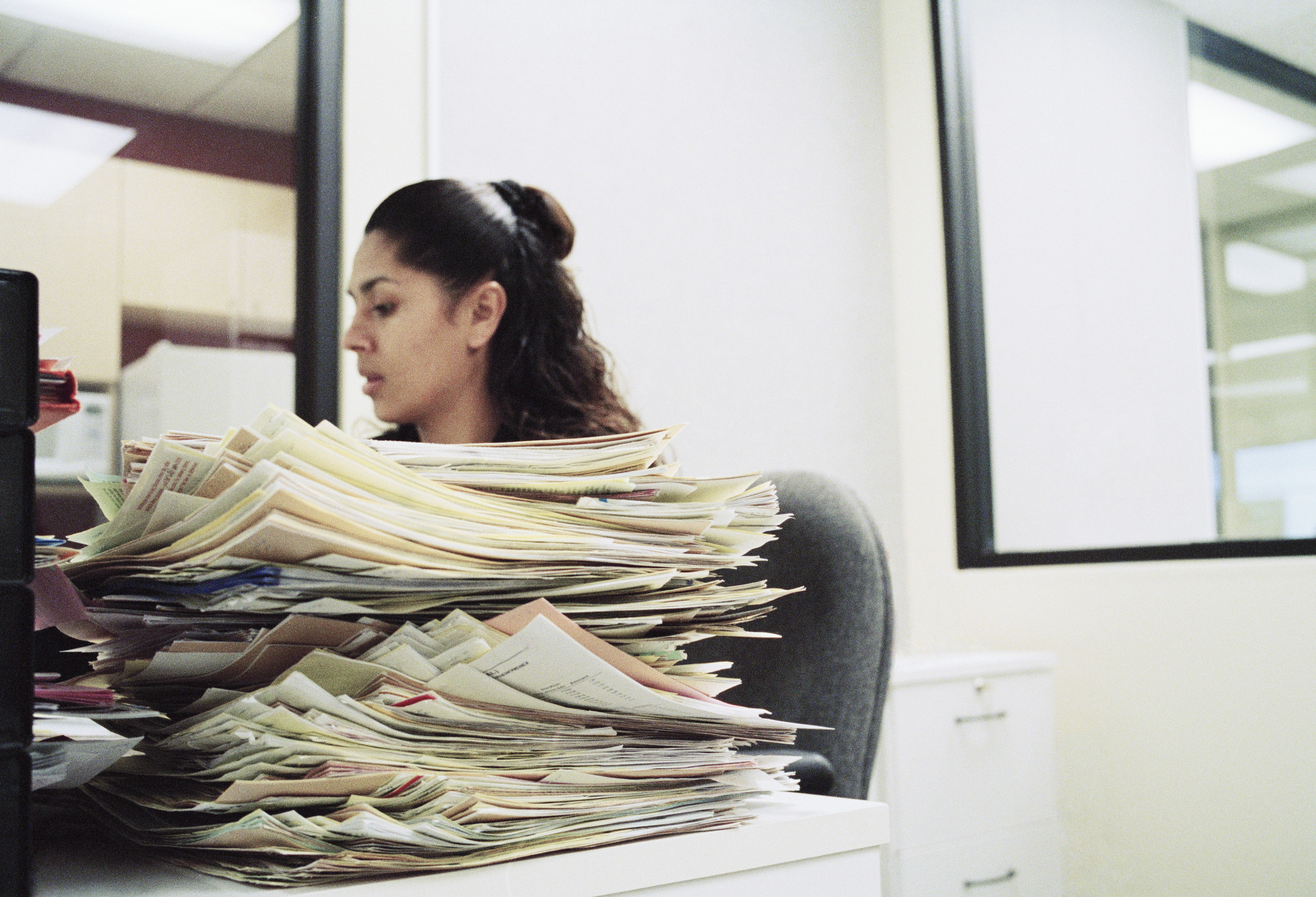 receptionist with a stack of paperwork