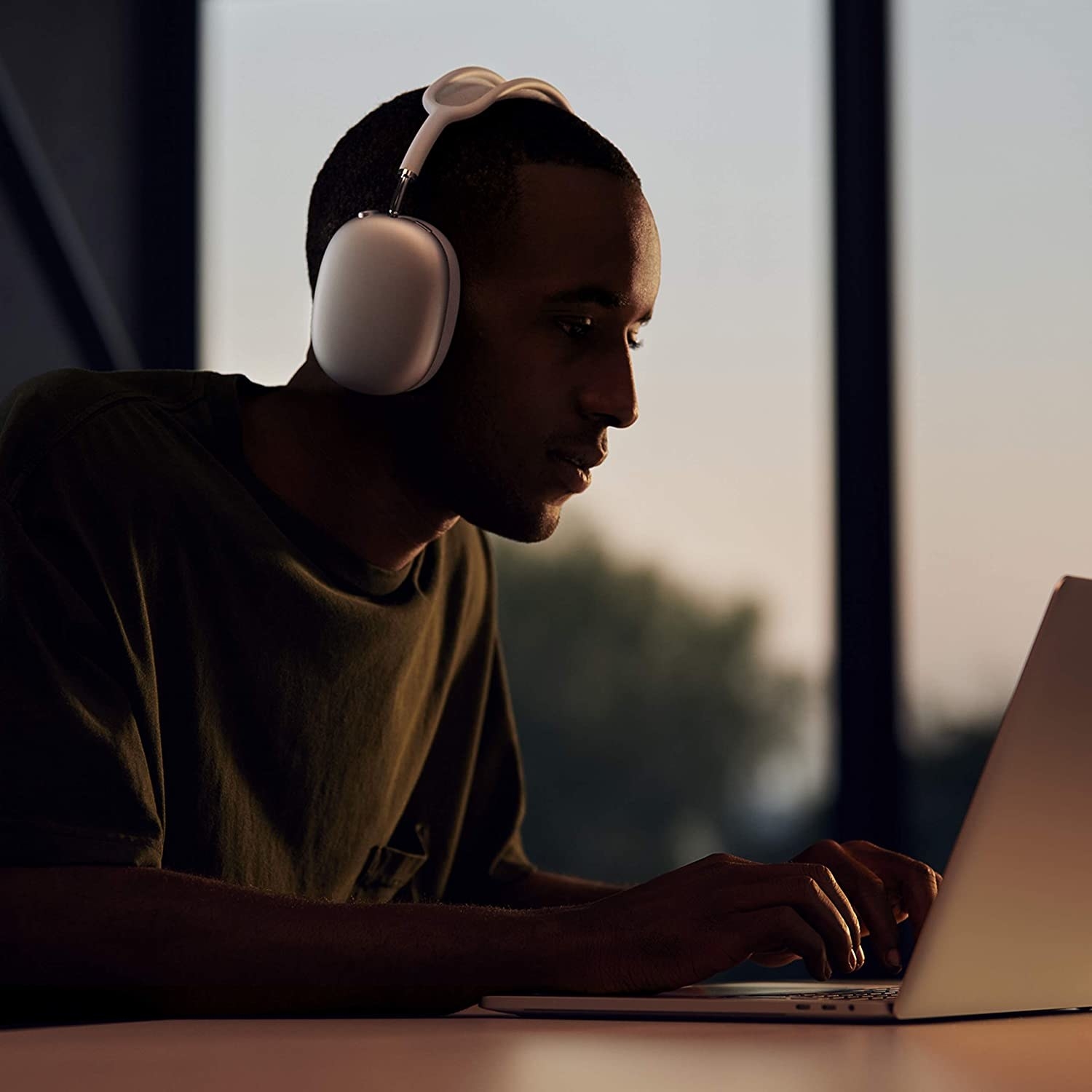 A person wearing the headphones while working on a computer