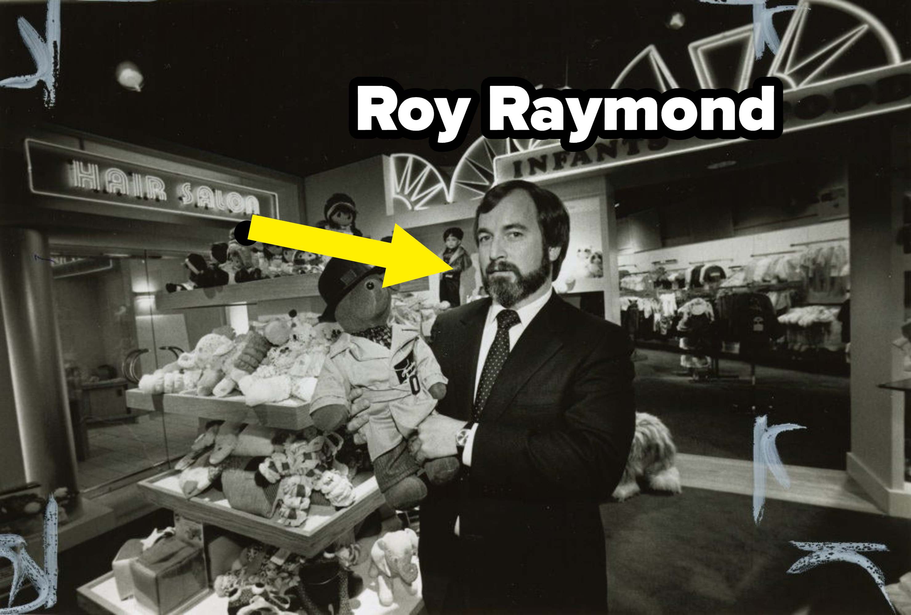 Roy Raymonf holding a stuffed animal in what appears to be a department store