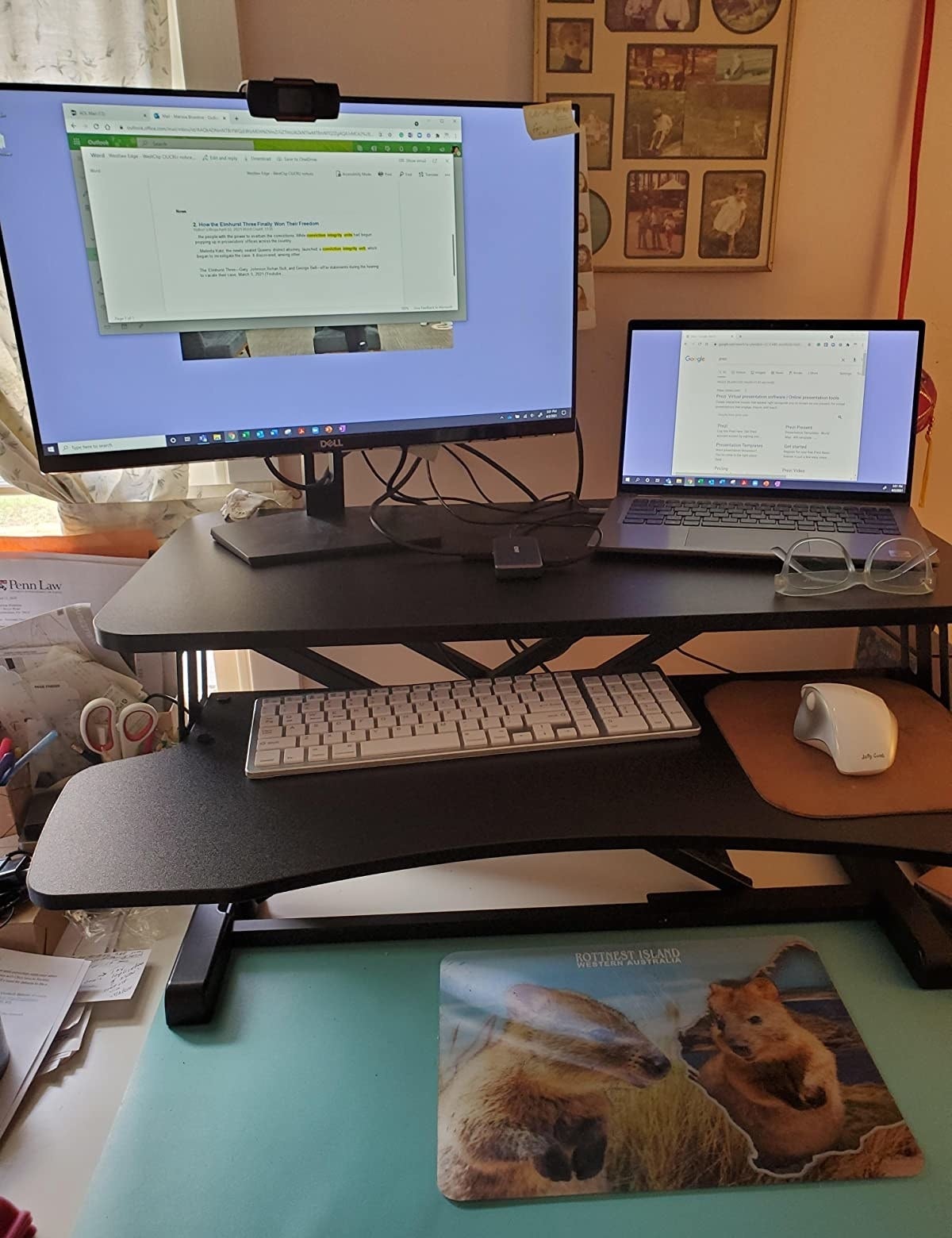 reviewer&#x27;s standing desk converter in use on traditional desk