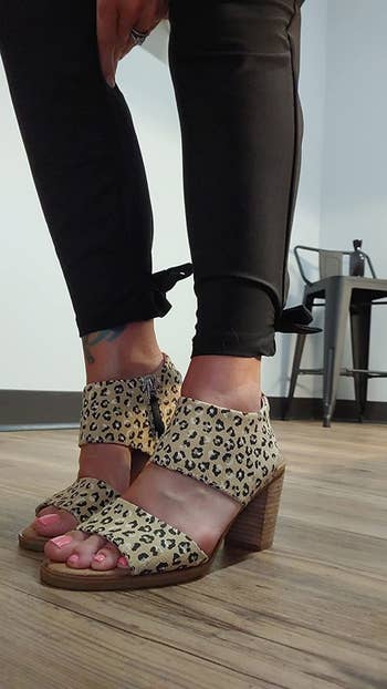 reviewer wearing same style sandal in a cheetah-print pattern