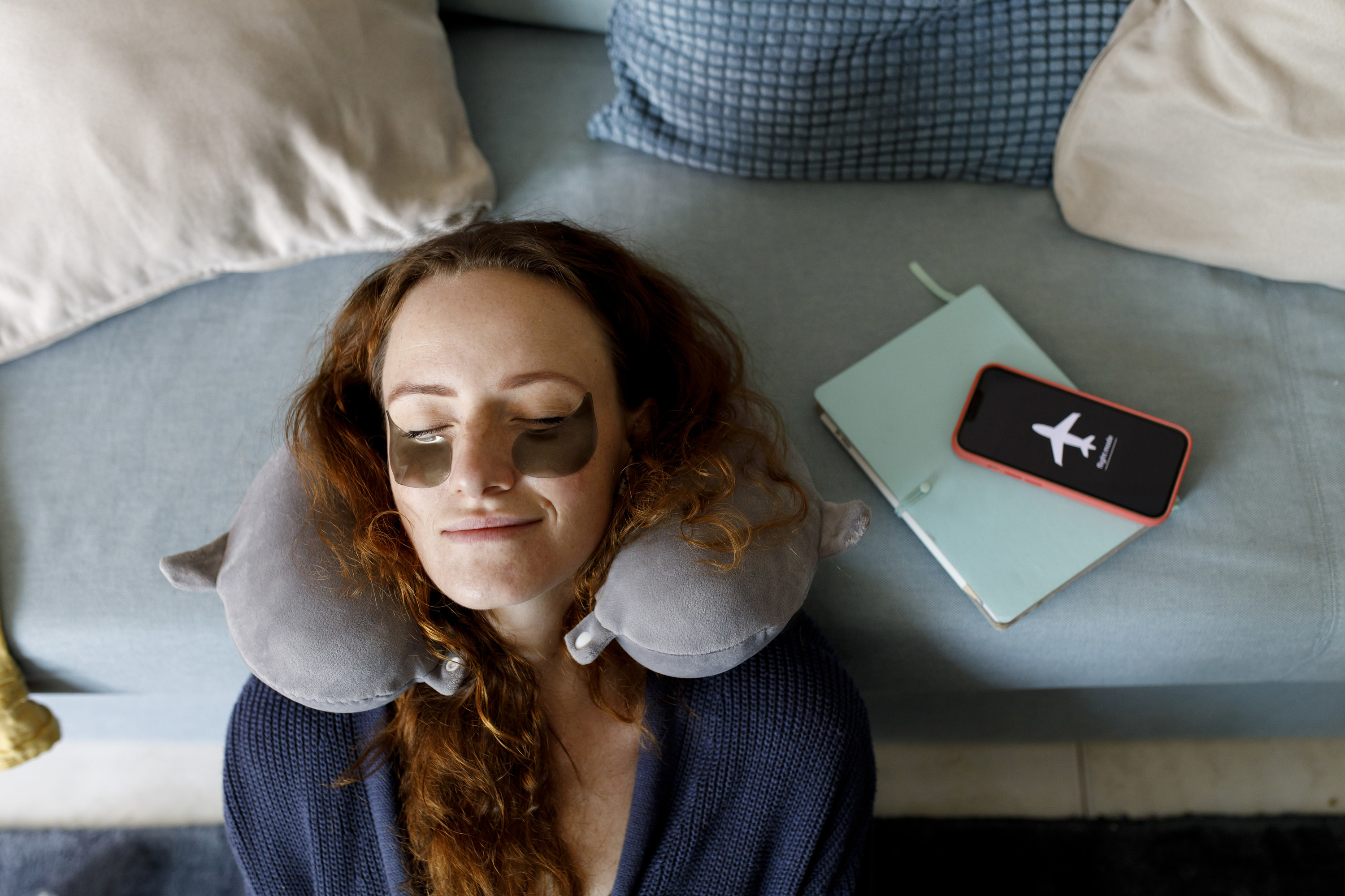 a woman sleeping with a neck pillow