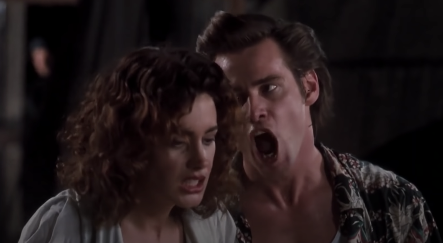 Jim Carrey yells in the ear of Sean Young