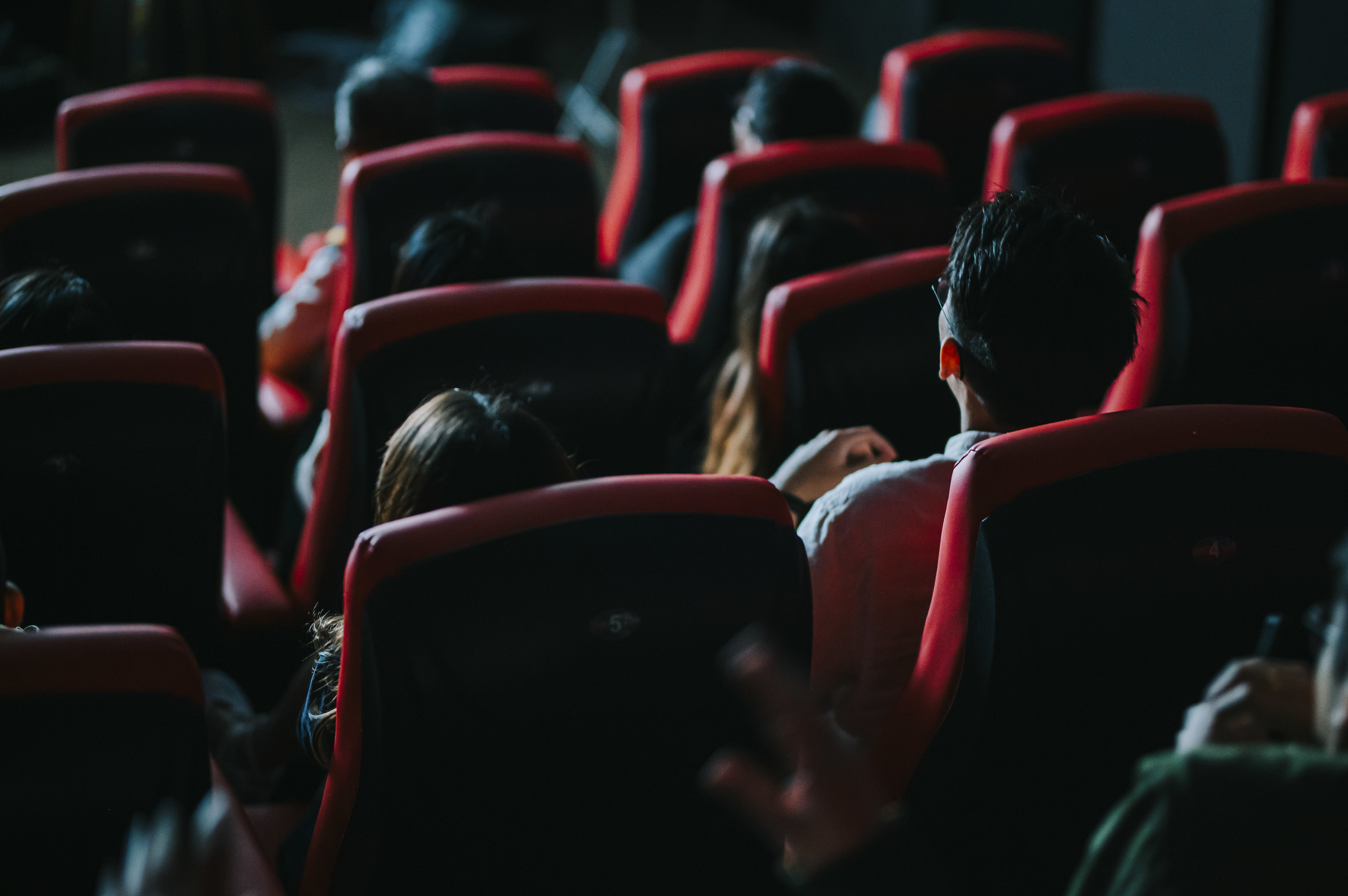 group of people in a theater watching a movie