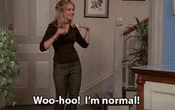 a woman dancing with the words, &quot;Woo-hoo! I&#x27;m normal!&quot;