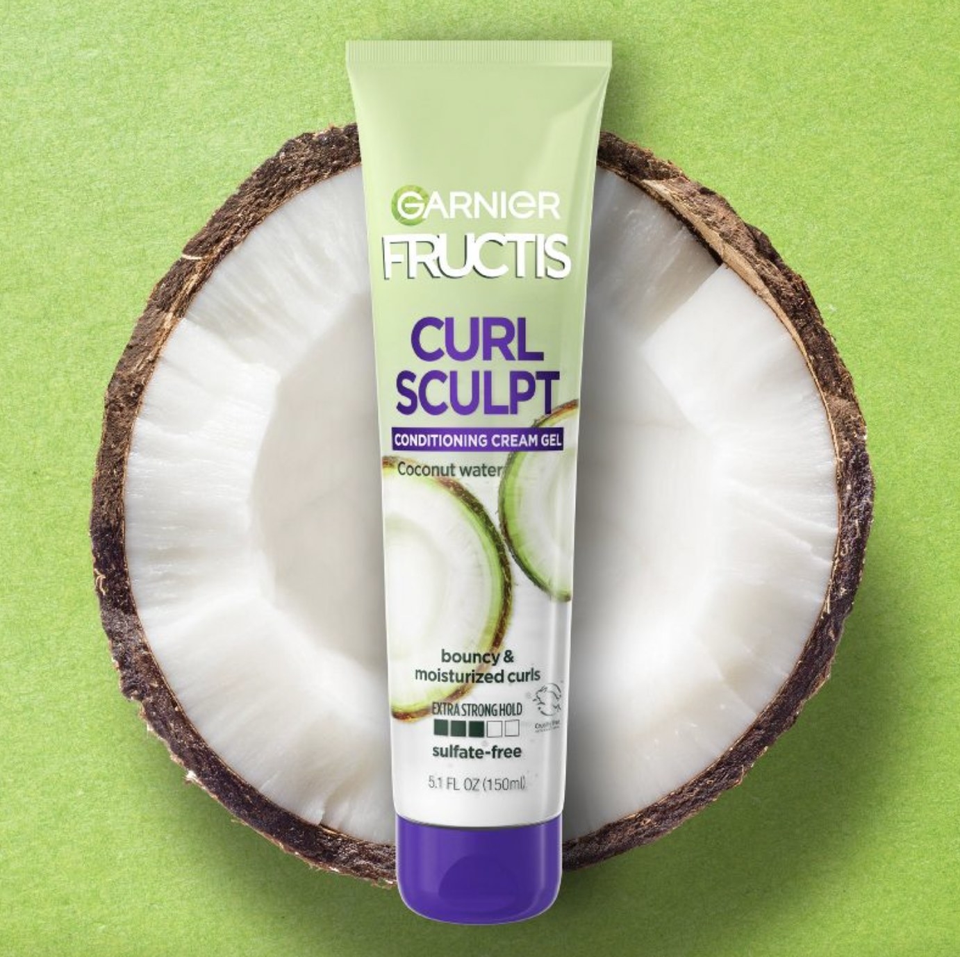 A tube of cream-gel on top of a cut coconut