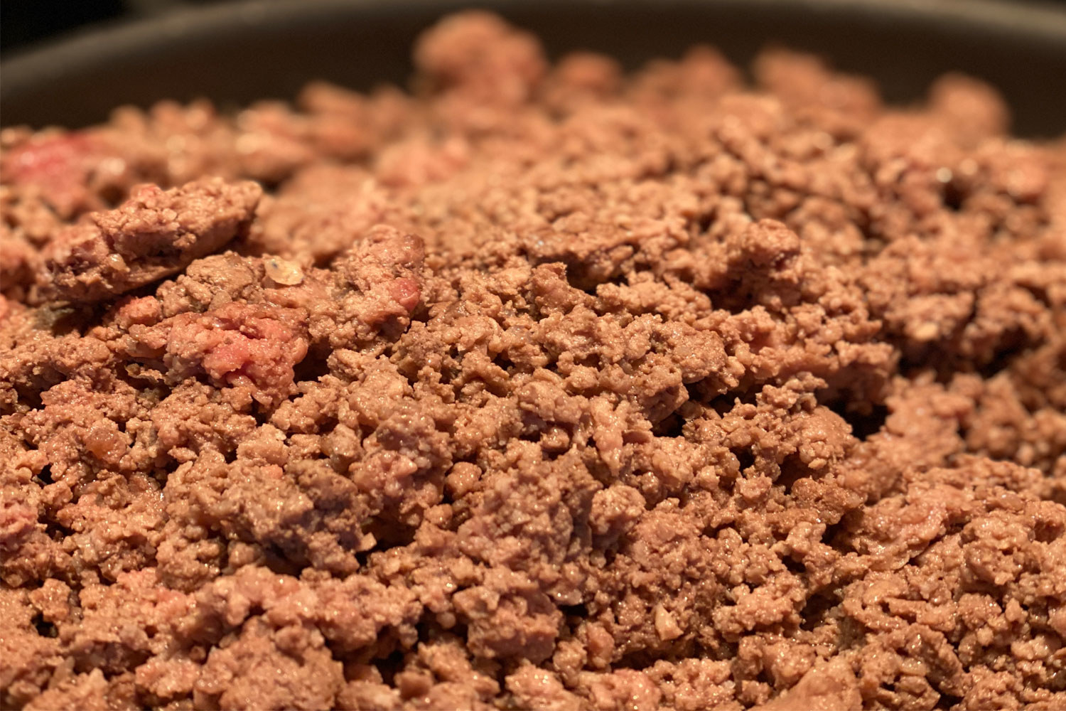 Ground beef in a skillet.