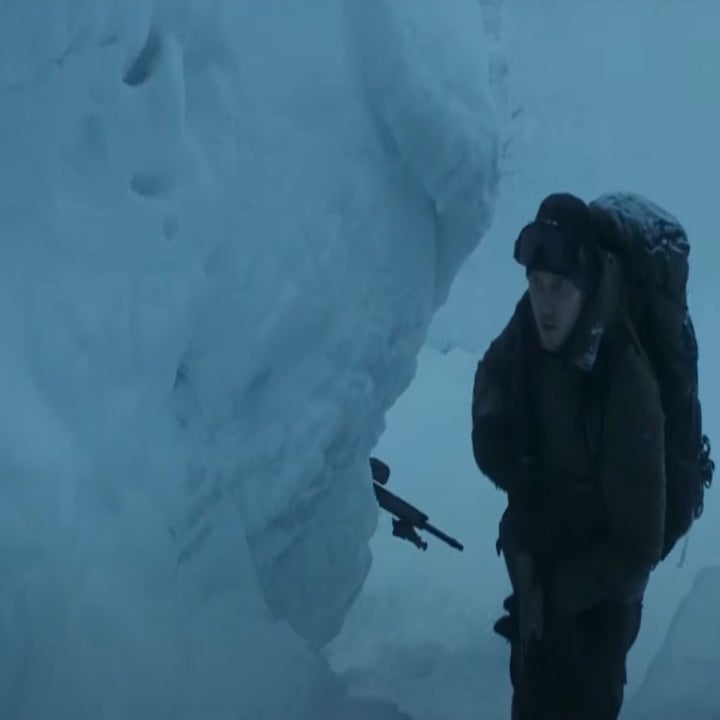 A man with a gun walking through Virkisjokull glacier