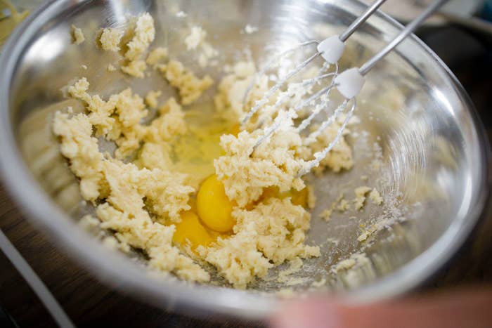 Mixing eggs into cake batter.