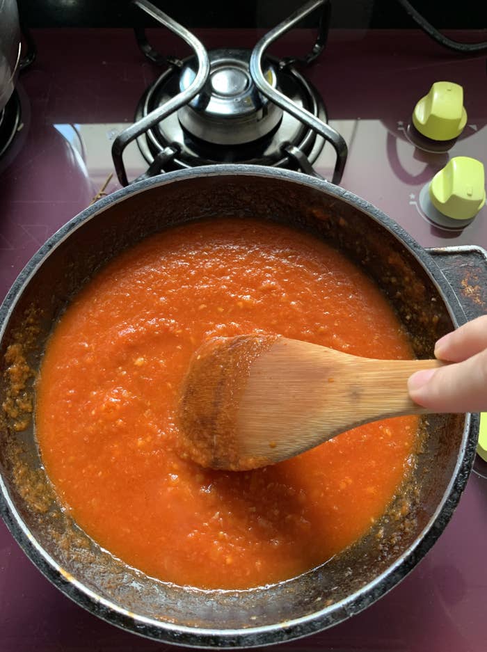 Stirring tomato sauce.