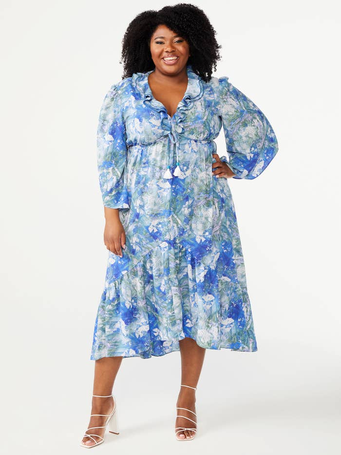 model wearing blue tie-dyed dress with white, strappy, heeled sandals