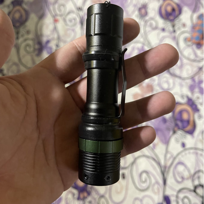 a reviewer photo of a hand holding the flashlight