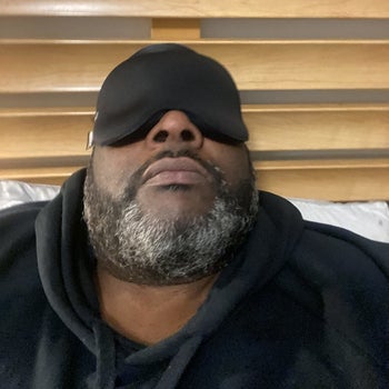 a reviewer wearing the black eye mask