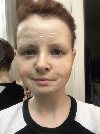 reviewer wearing zombie face mask