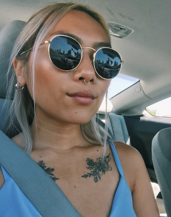reviewer wearing round circle glasses in car