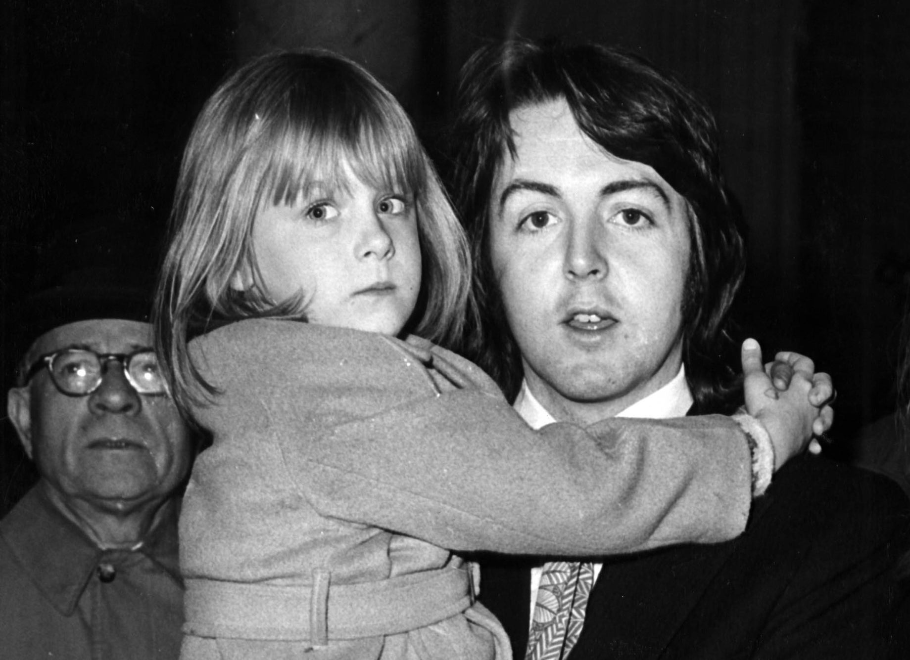 Paul McCartney holding his child stepdaughter, Heather