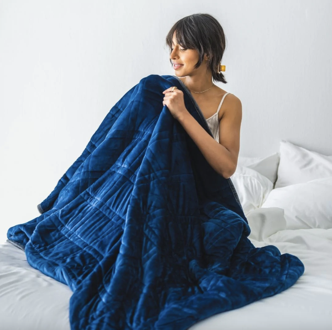 model snuggling with navy minky weighted blanket
