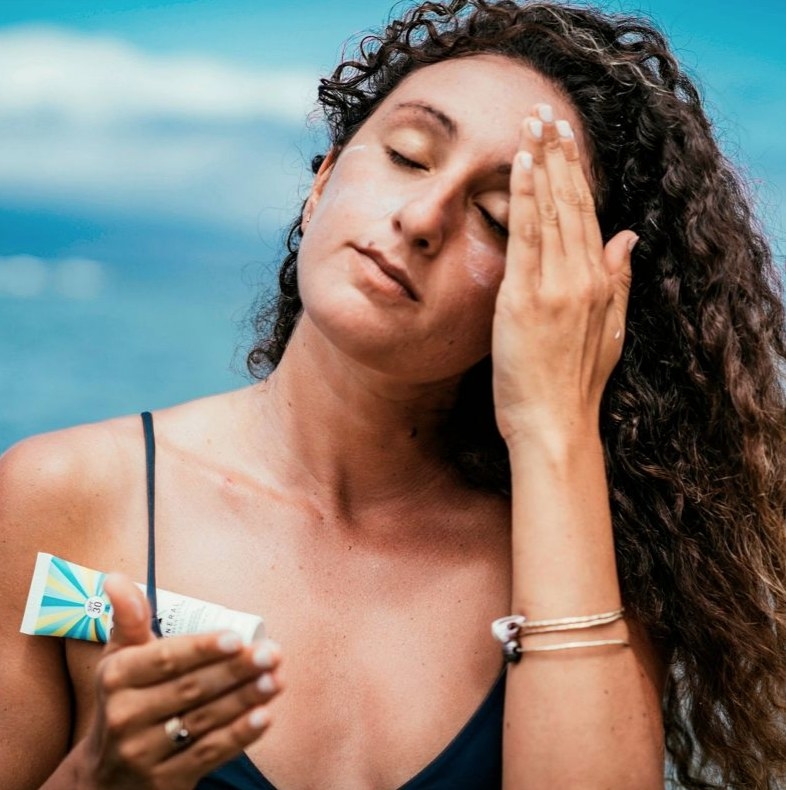 A model putting on face sunscreen