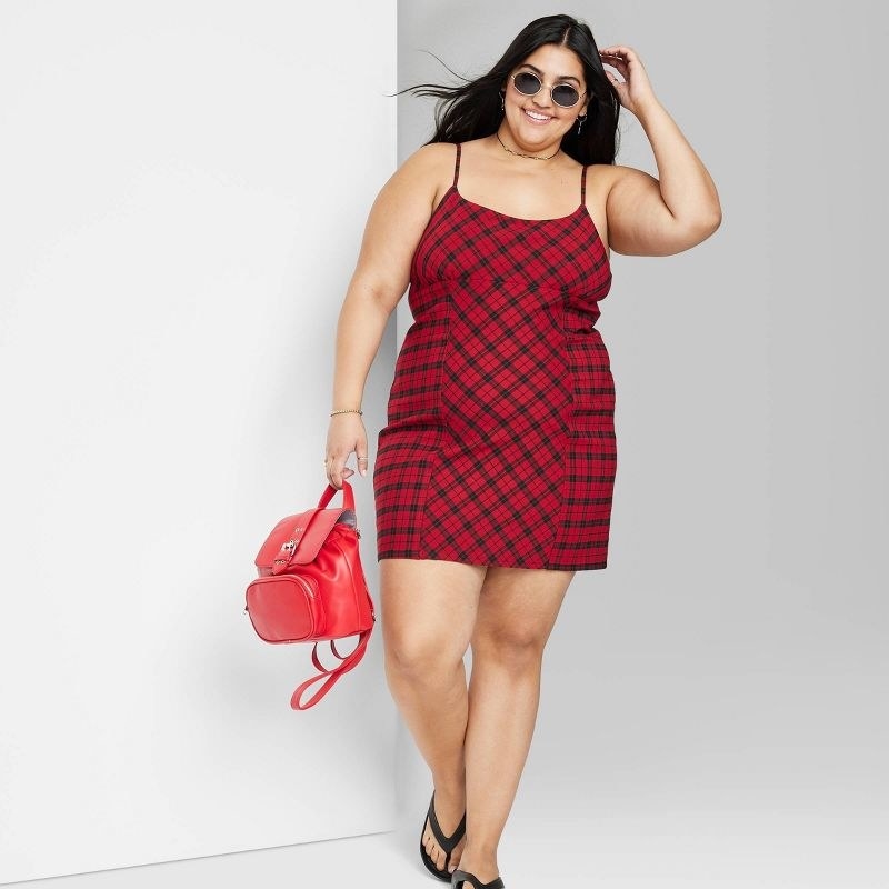 model wearing the dress in red plaid