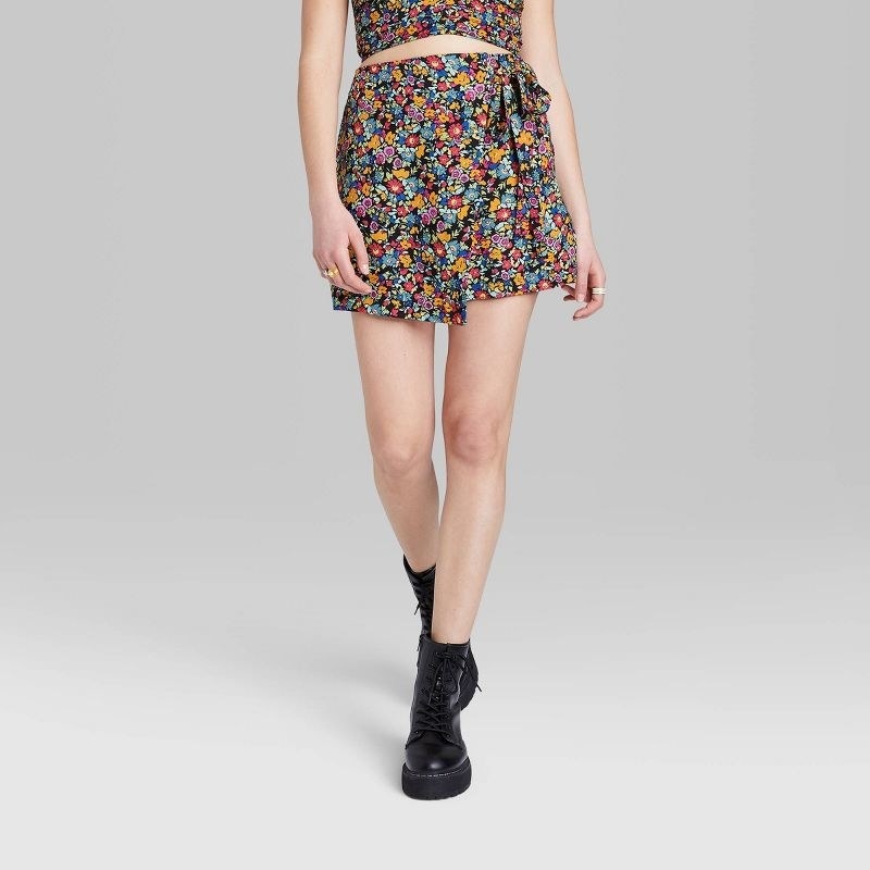model wearing the skirt in black and floral print