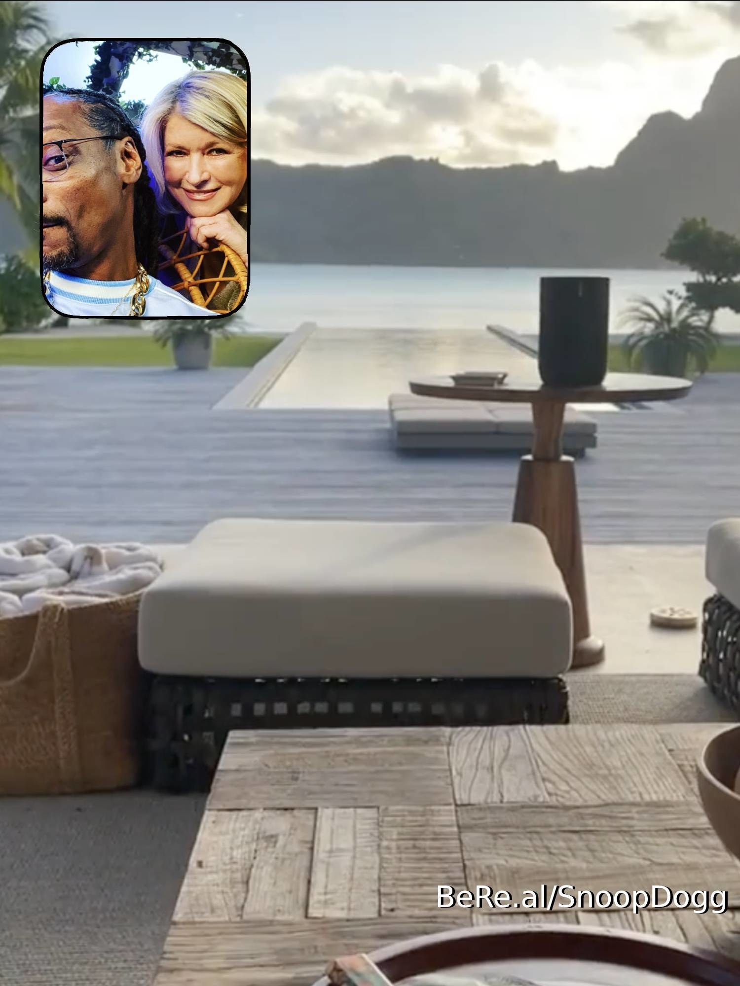 Snoop and Martha together, a backyard patio with a lake and mountains in the distance