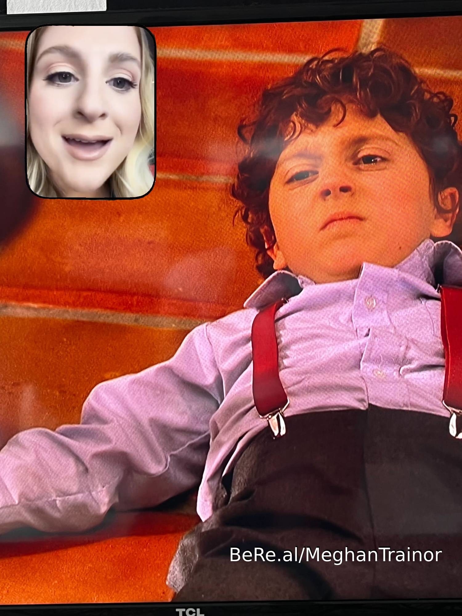 Meghan Trainor smiling at a clip of her husband, Daryl Sabara, as a child actor in Spy Kids