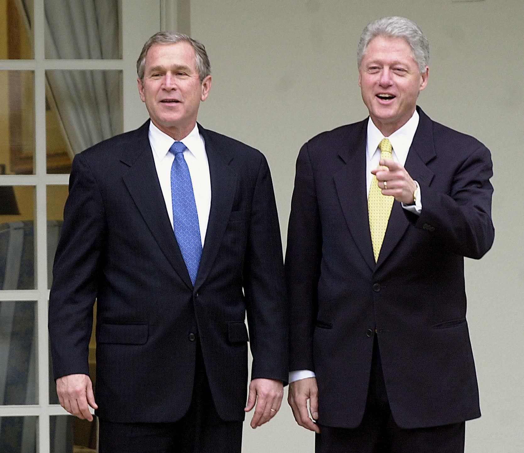 GW Bush and Bill Clinton standing together