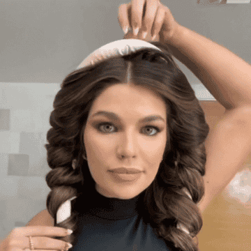 GIF of person taking the curling rod out of their hair and releasing curls