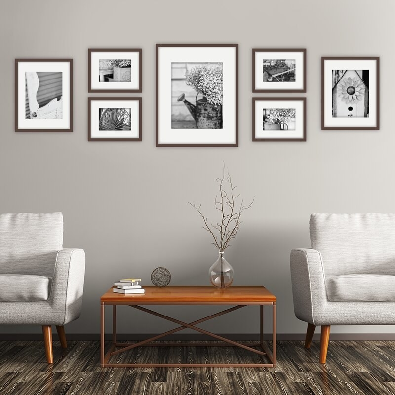 the walnut frames mounted on a gray wall