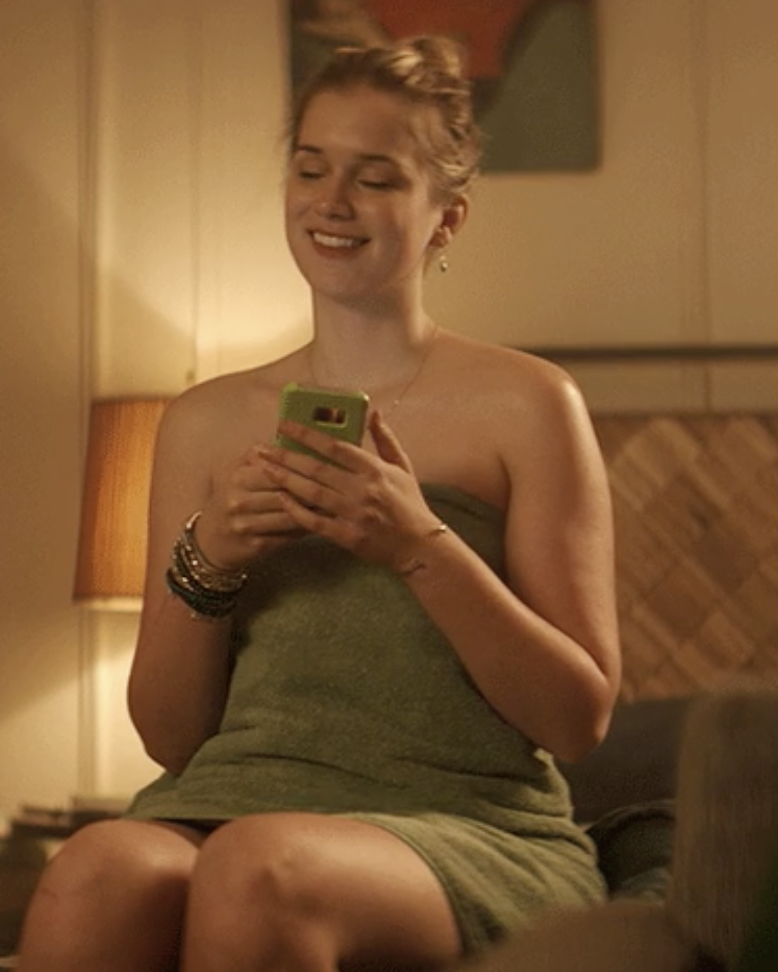 A woman on her phone smiling