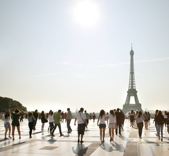 Tourists walking near the Eiffel Tower.
