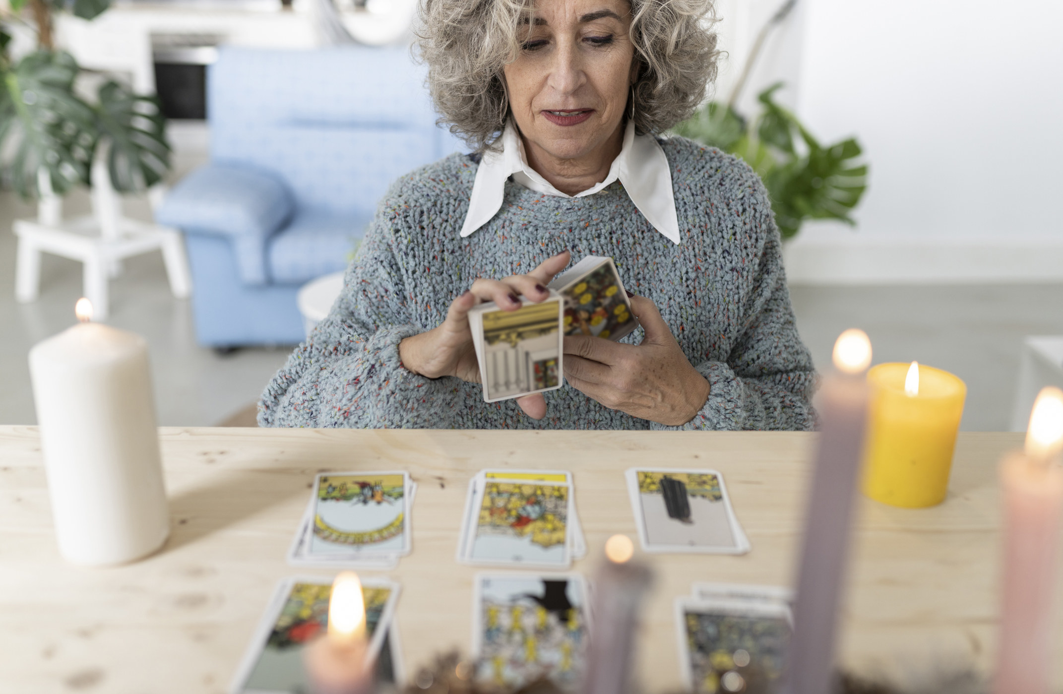 A person shuffling some tarot cards during a reading