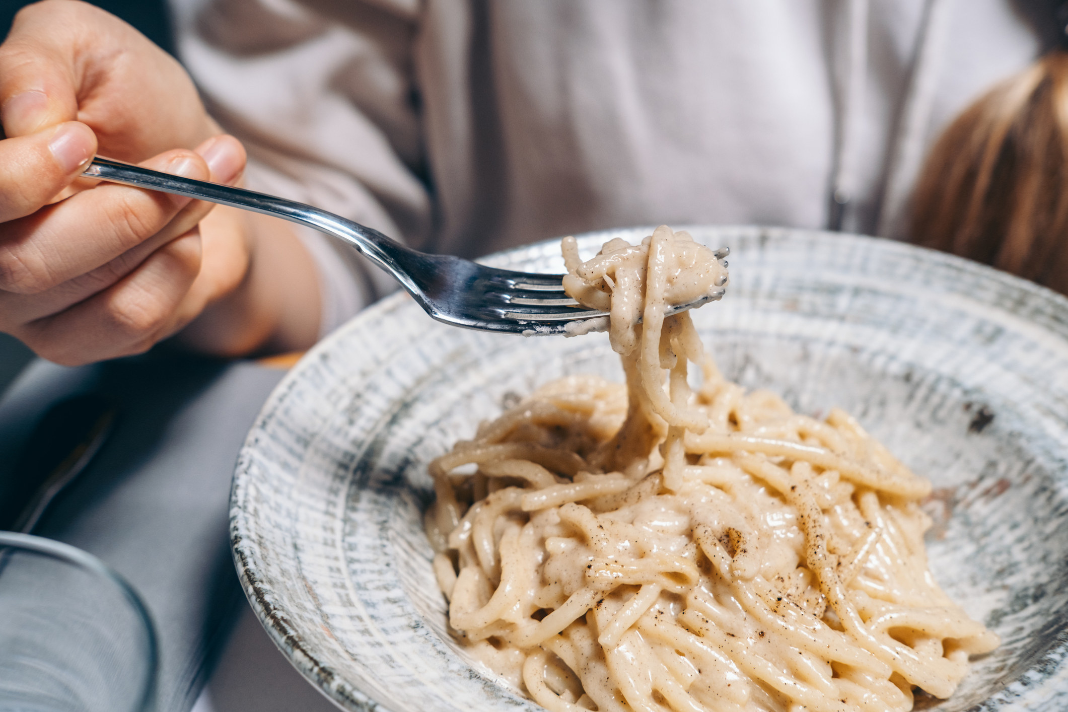 Creamy pasta on a fork.