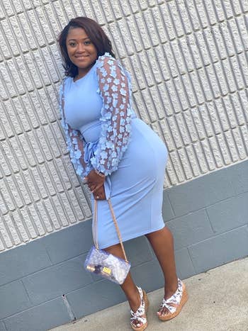 reviewer wearing the mid-calf length dress in blue