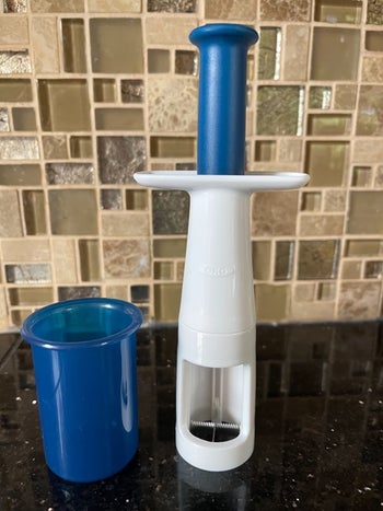 reviewer's photo of the grape cutter in their kitchen