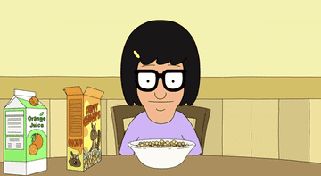 Tina Belcher cheers and raises her hands in the air
