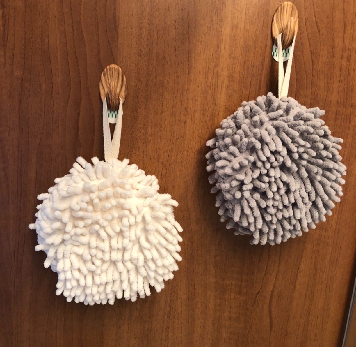 reviewer image of the towels hanging on hooks on a wooden wall
