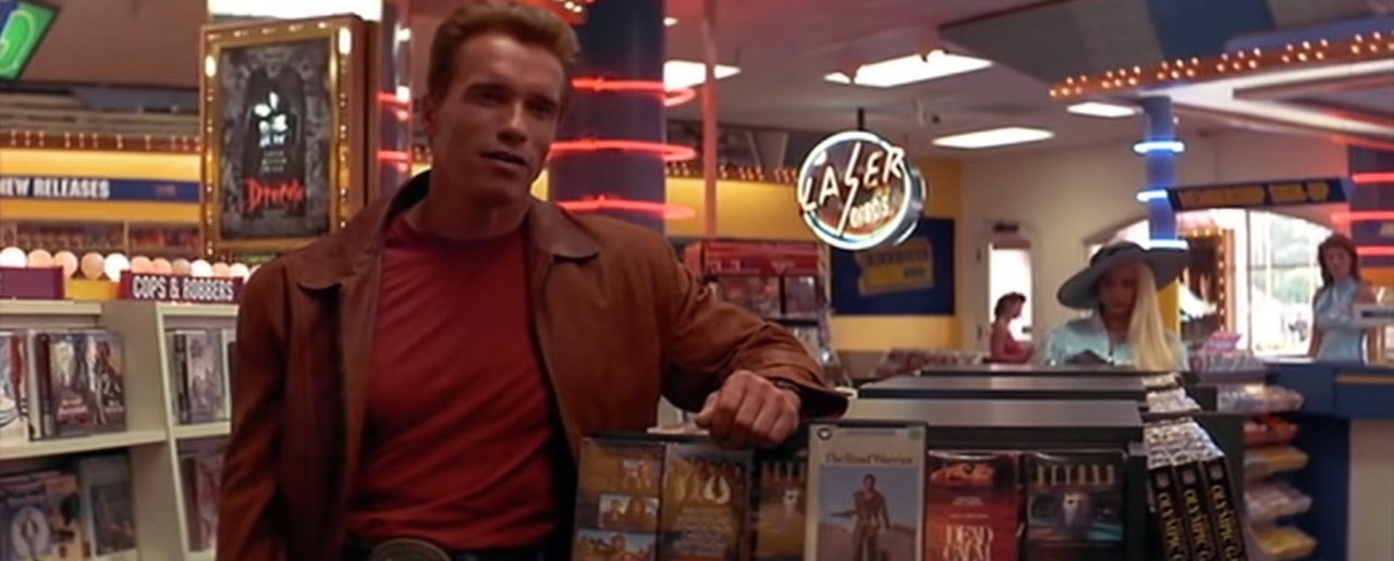 Arnold Schwarzenegger in Last Action hero standing in a video store