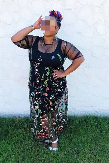 another reviewer posing in the black floral dress