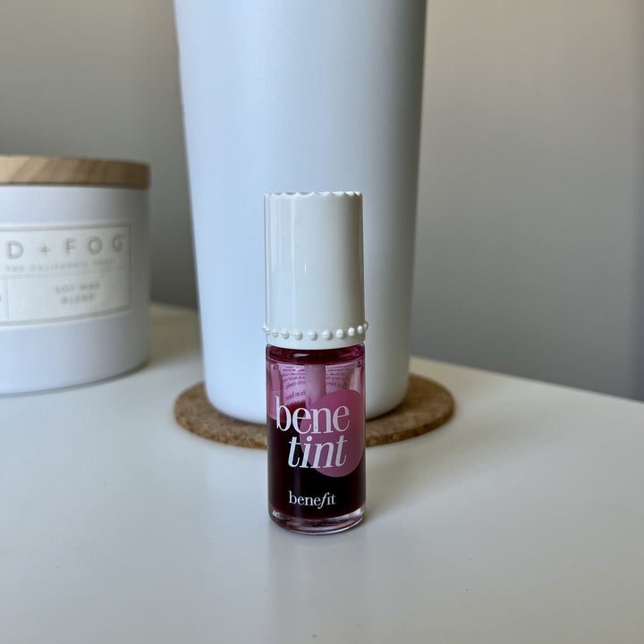 The bottle of lip and cheek stain on a desk